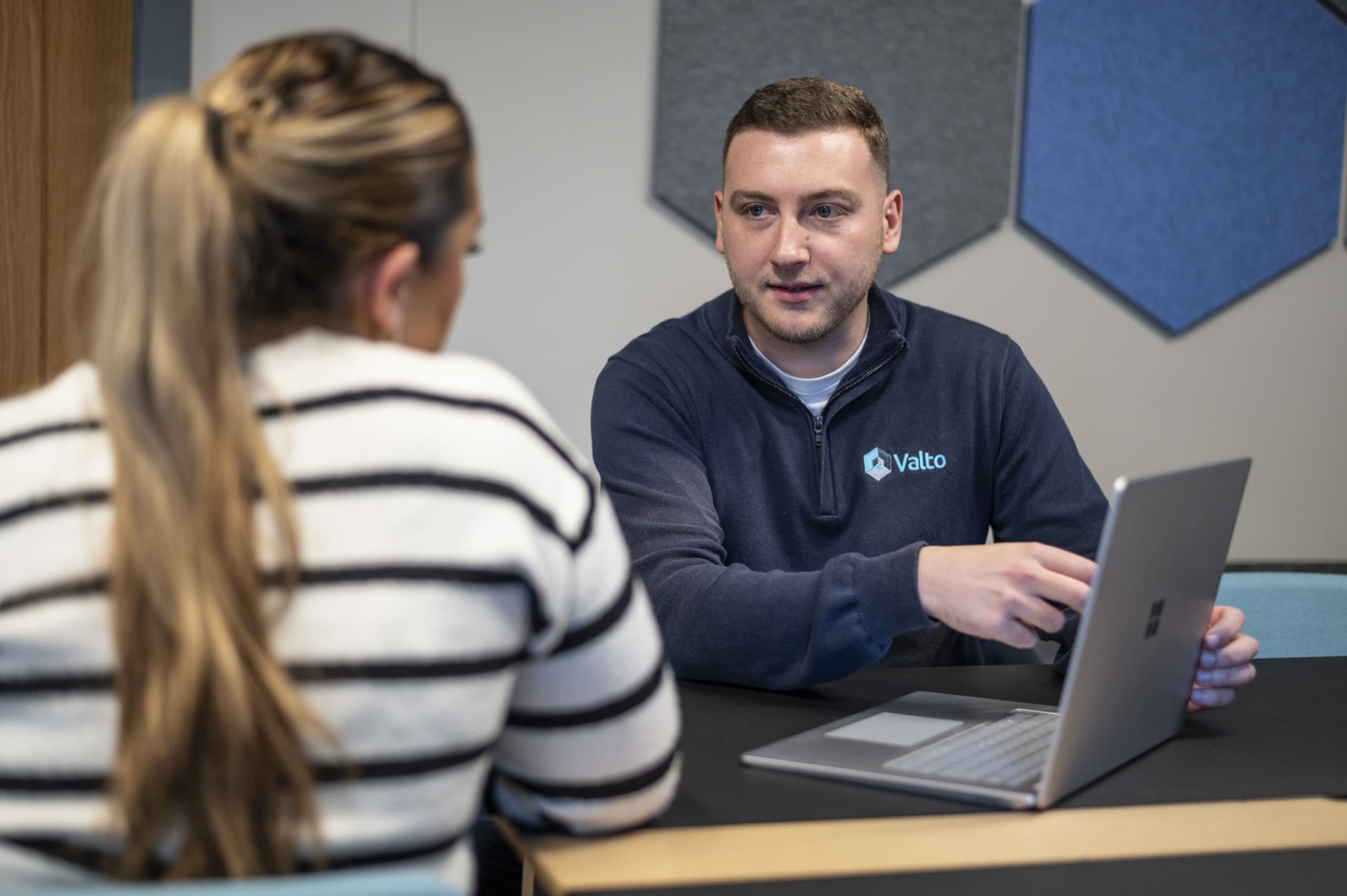 two people in a meeting with a laptop